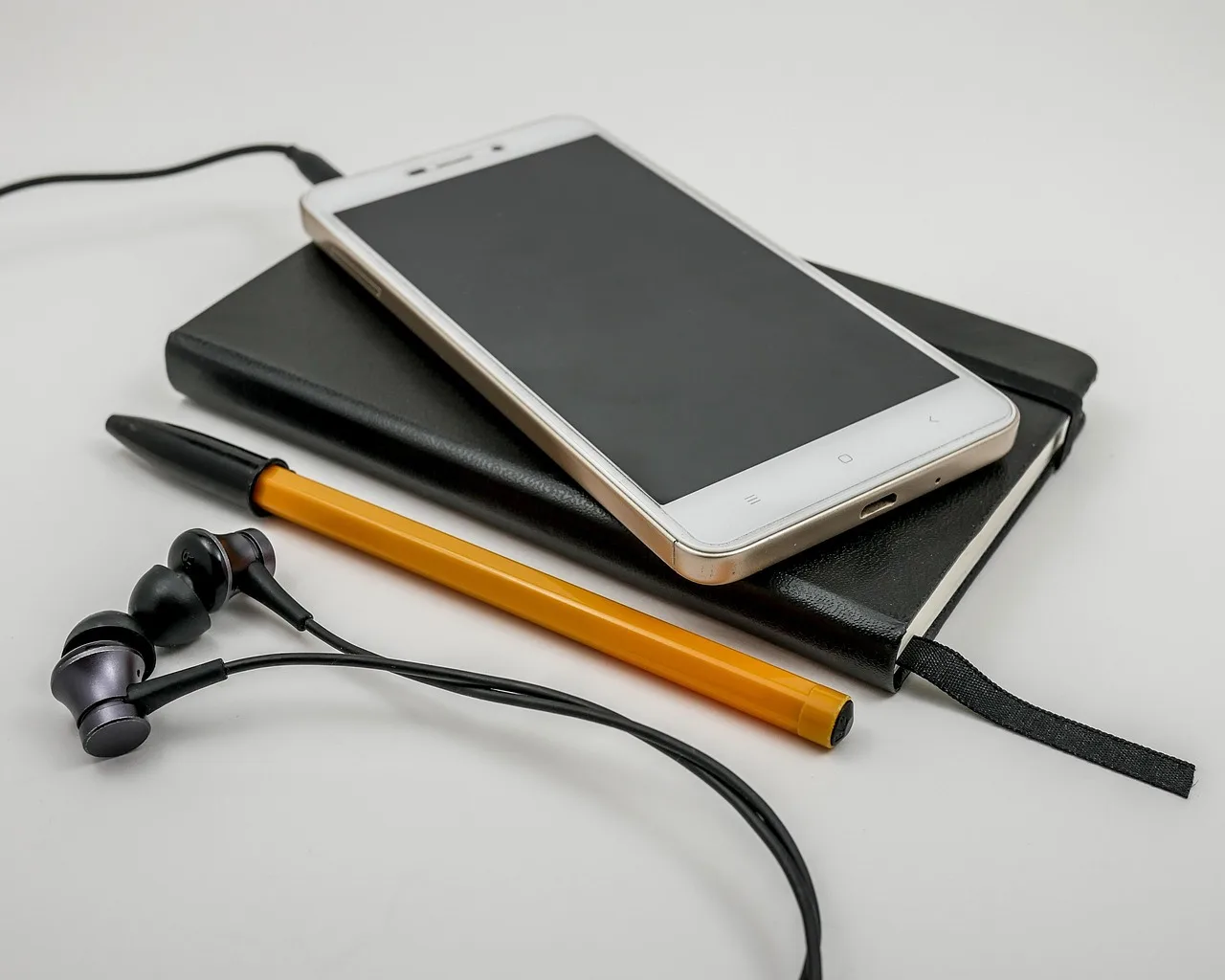 telephone, headphones, technology, smartphone, screen, communication, electronics, office, contact, sms, cell, business, white, notes, pen, black, orange, notebook, diary. Marketing automation best practices start with the outcome, not the tool