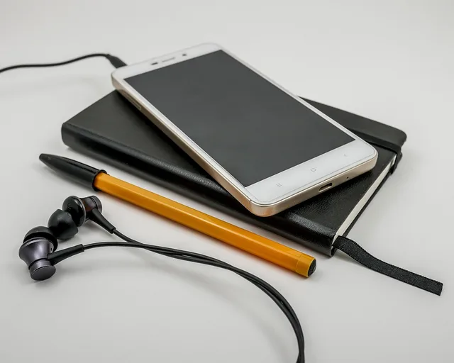telephone, headphones, technology, smartphone, screen, communication, electronics, office, contact, sms, cell, business, white, notes, pen, black, orange, notebook, diary. Marketing automation best practices start with the outcome, not the tool