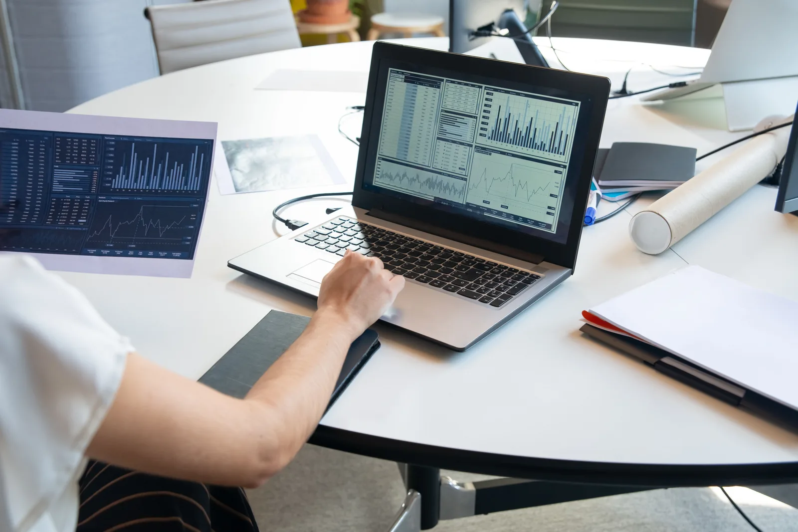 Business person evaluating financial charts on a laptop in a modern office setting. Marketing automation case studies: what to verify