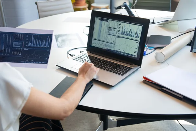 Business person evaluating financial charts on a laptop in a modern office setting. Marketing automation case studies: what to verify
